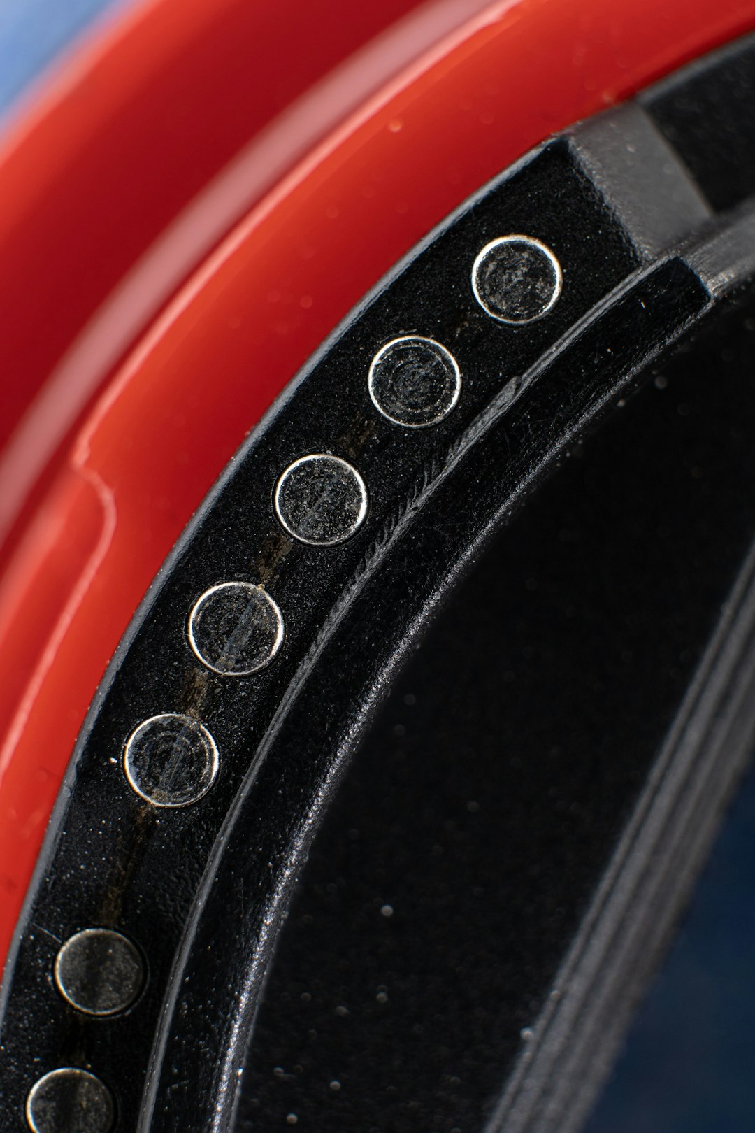 service-03 a-close-up-of-a-red-and-black-metal-object-tddujmgnlhi